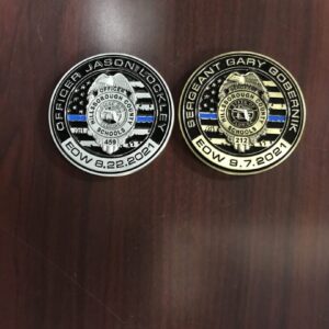 Two police badges are on a table.