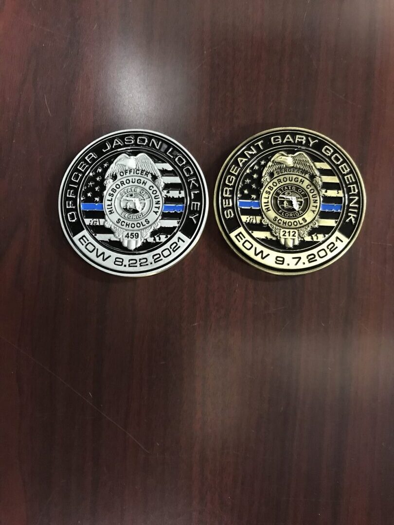 Two police badges are on a table.